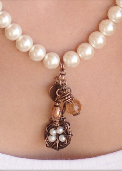 Each bird's nest charm necklace is custom made with a pearl egg 