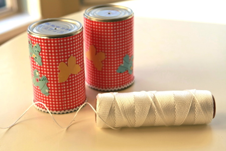 Decorated cans with holes punched and string for the phone line.