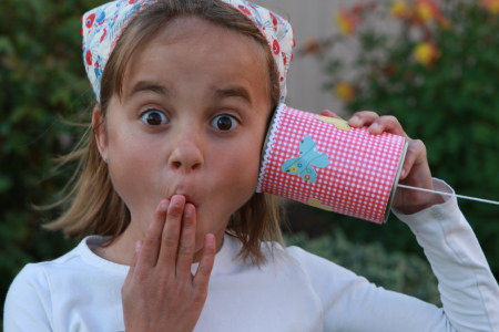 Little girl surprised by what she is hearing.